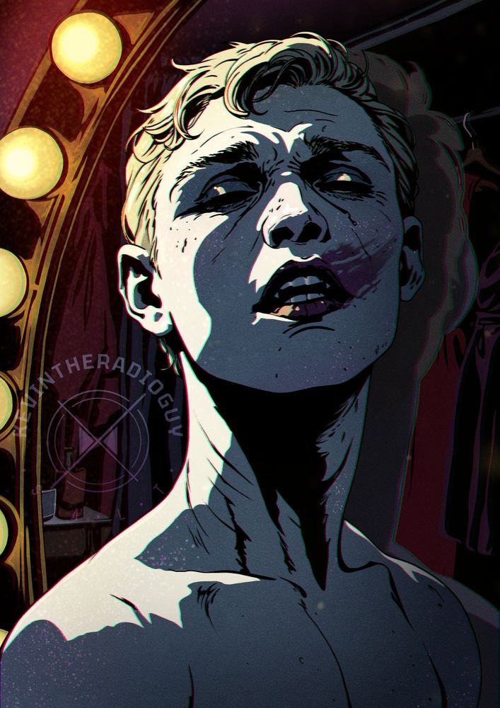 A shirtless albino man with vampire fangs stands before a mirror framed by bright vanity lights. His face is tilted upward, partially cast in harsh shadow, with lighting emphasising the structure of his jaw and neck. His expression is somewhere between dazed, pained, and entranced. A large smudge of dark lipstick stains his cheek and mouth. The background includes hanging clothes and makeup tools, indicating a dressing room or backstage setting. 