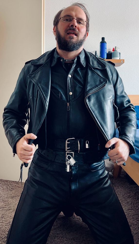 Me in a rubber suit, a few leather layers and a heavy jacket all locked, enjoying some time with a fat plug in when I got a bit greedy! 