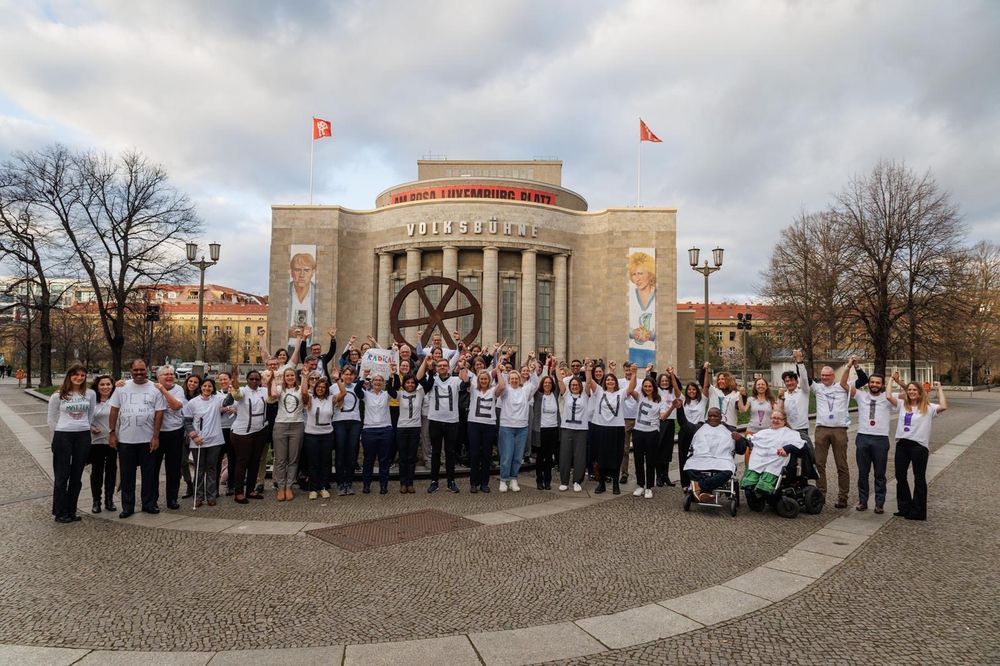 The IDDC members wearing white shirts spelling out hold the line.