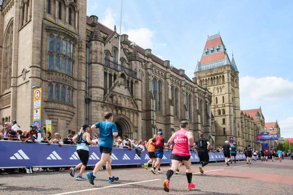 Runners cross finish line at The University of Manchester for Manchester Marathon 2025