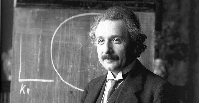 albert einstein in front of a blackboard