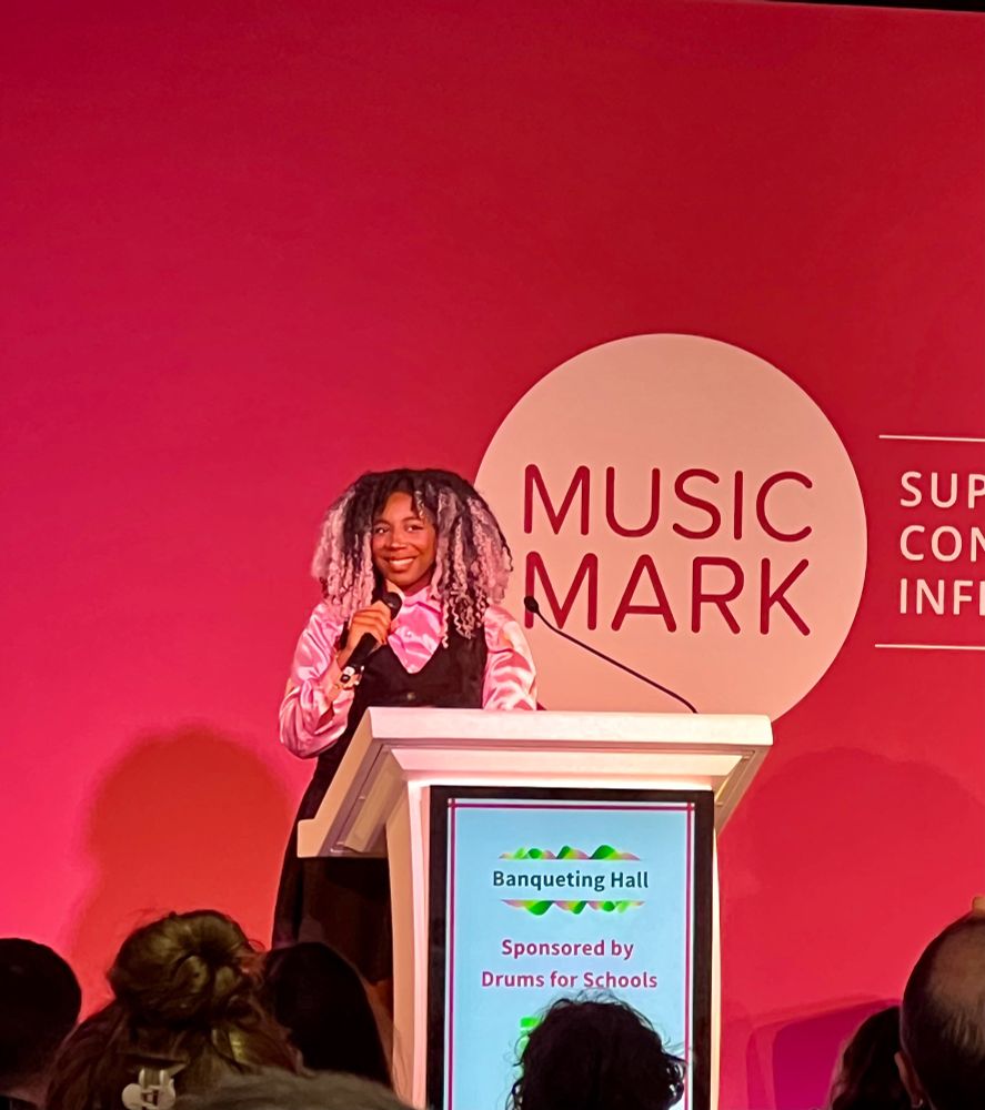 Dominique Palmer on stage at the Music Mark Conference. 