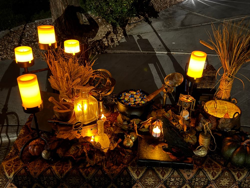 A close-up of the candles, cauldrons, pumpkins, and other paraphernalia on my bog, which table