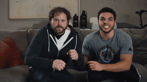 Two guys watching a sports play. They stand up slowly, saying "yes yes yes yes" as they rise -- until a final payoff where the team scores, and they celebrate. 