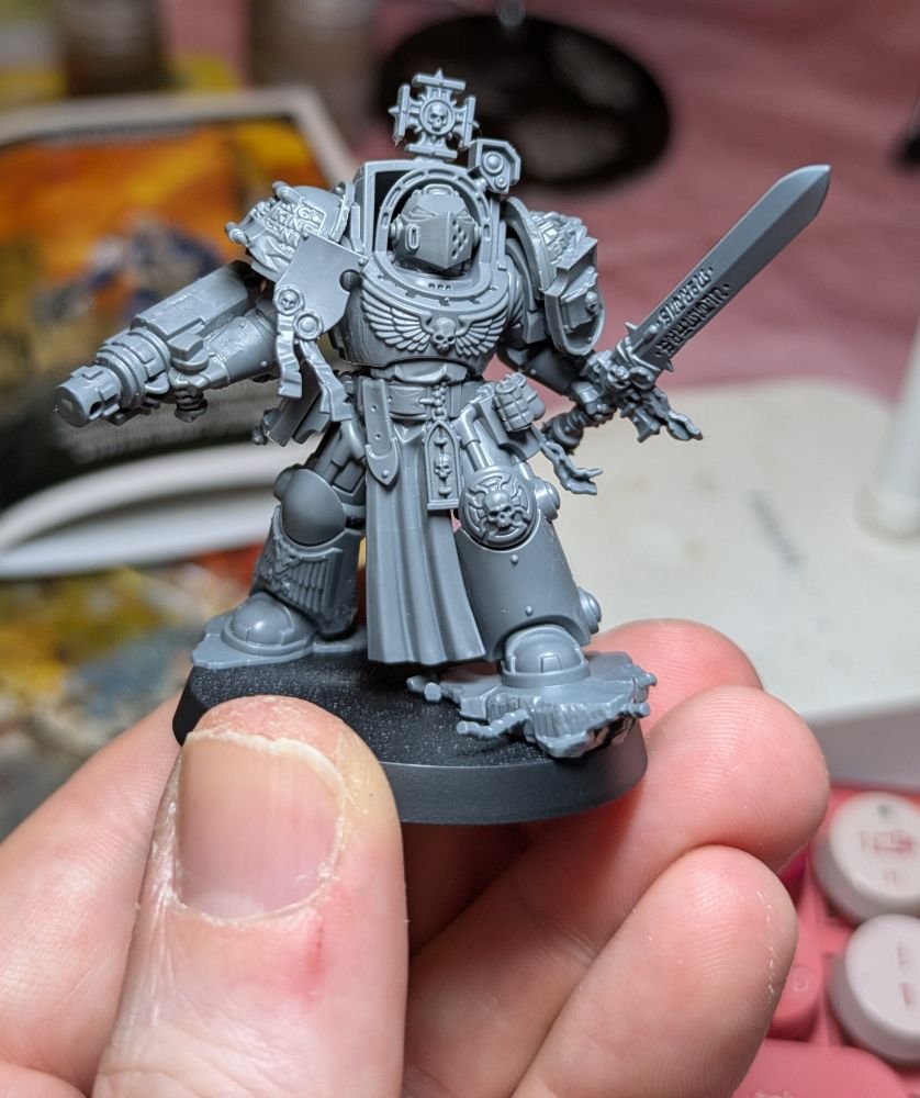 A converted Grey Knight Grand Master with psycannon, held in my hand. He has plenty of purity seals and oath of moments billowing in the wind. 