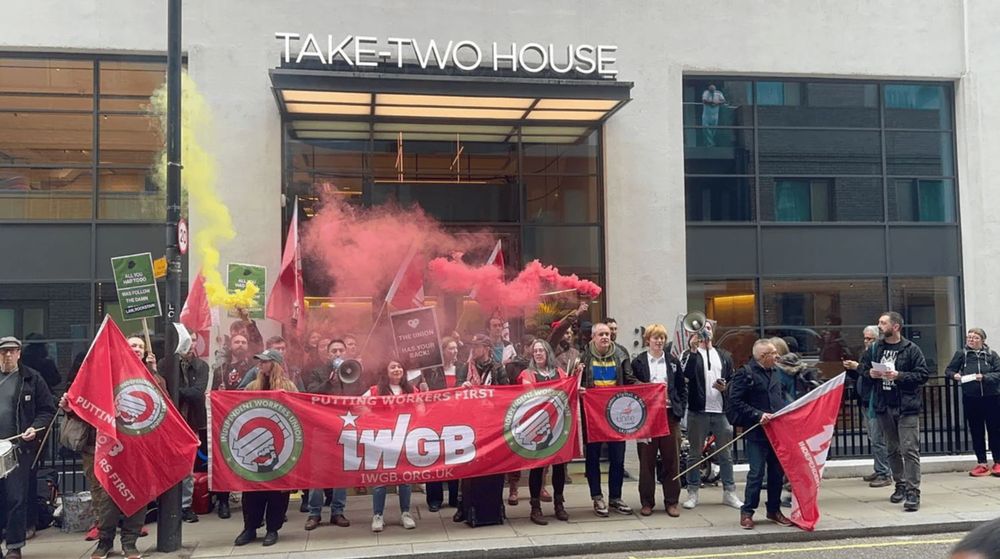 IWGB union members protesting on the street, holding red banners