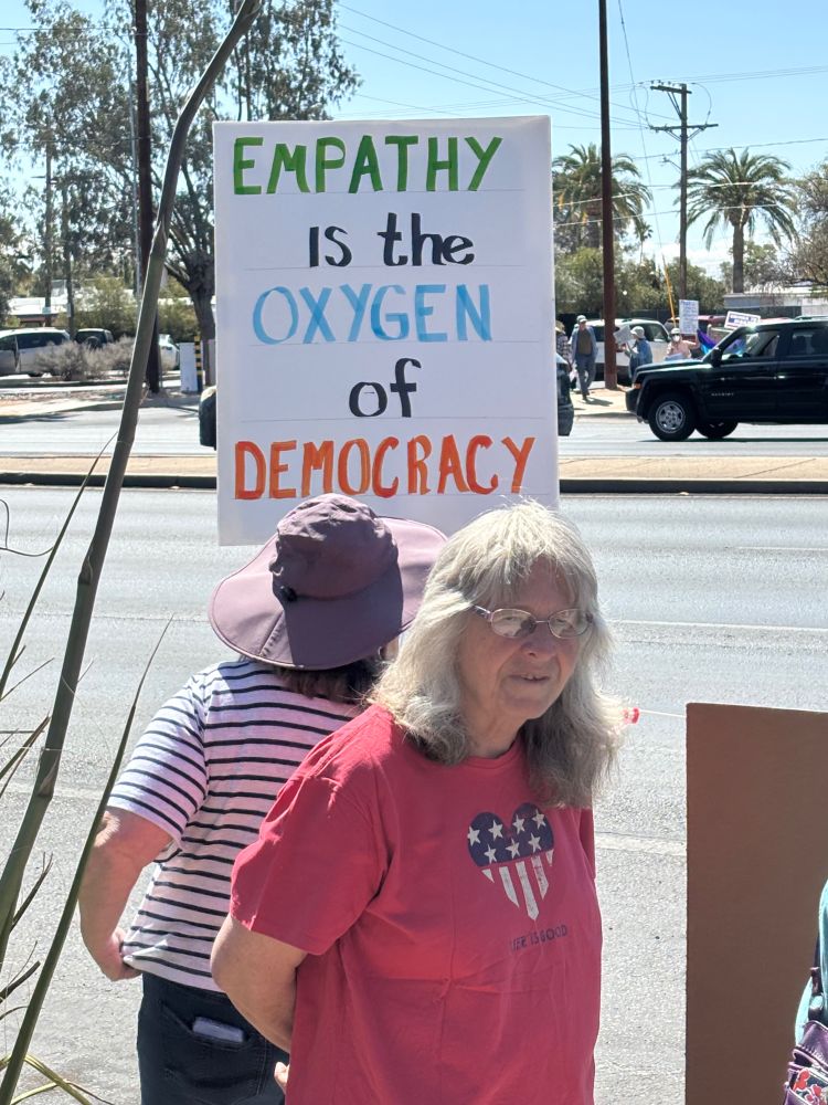 “Empathy is the oxygen of democracy” sign at Tucson Hands Off rally.