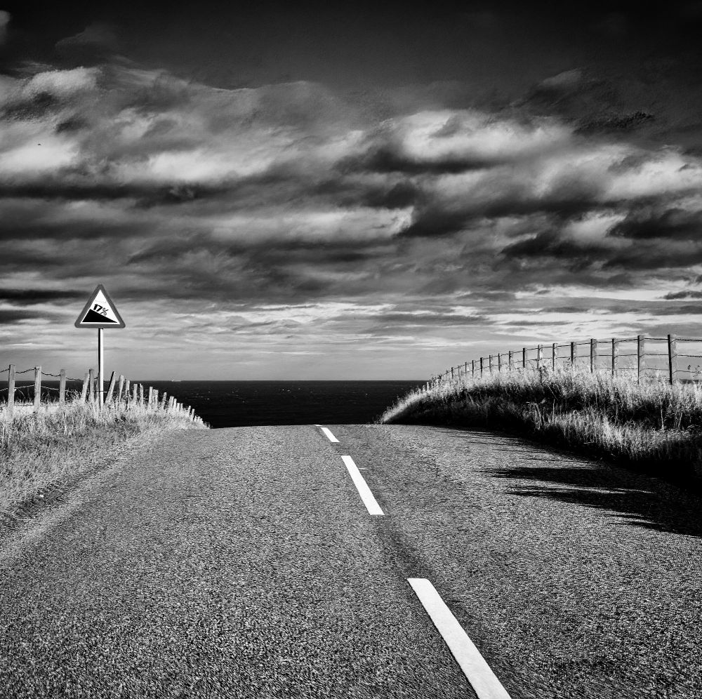 Black and white picture of a roadway disappearing over  hill, with a road sign on the left showing a 17% slope.

Olympus TG-4
4.5-18mm f/2-4.9
@ƒ/4.5 9.6 mm 1/640s ISO100