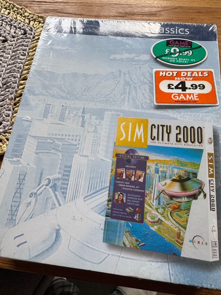 EA Classics Sim City 2000 big box, still in the shrink wrap.

Two price stickers from Game. One £9.99 (crossed out) and one £4.99