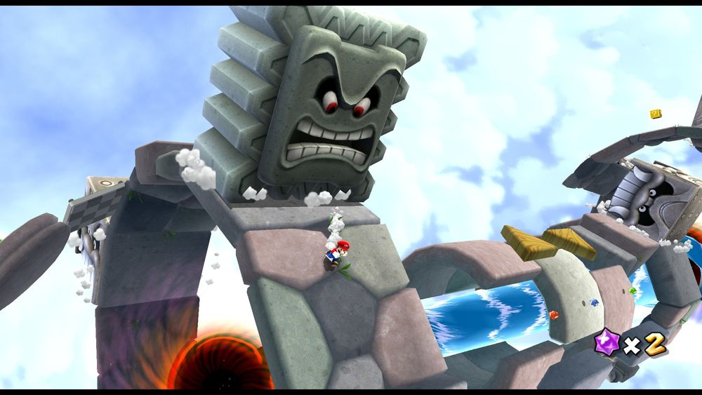 Screenshot from the game Super Mario Galaxy. Depicts the hero Mario running across a cobblestone ring formation floating around a black hole, as a large stone Thwomp creature glares menacingly at him after having slammed into the nearby tile. Other floating stone platforms and a long current of water can also be seen in the background.