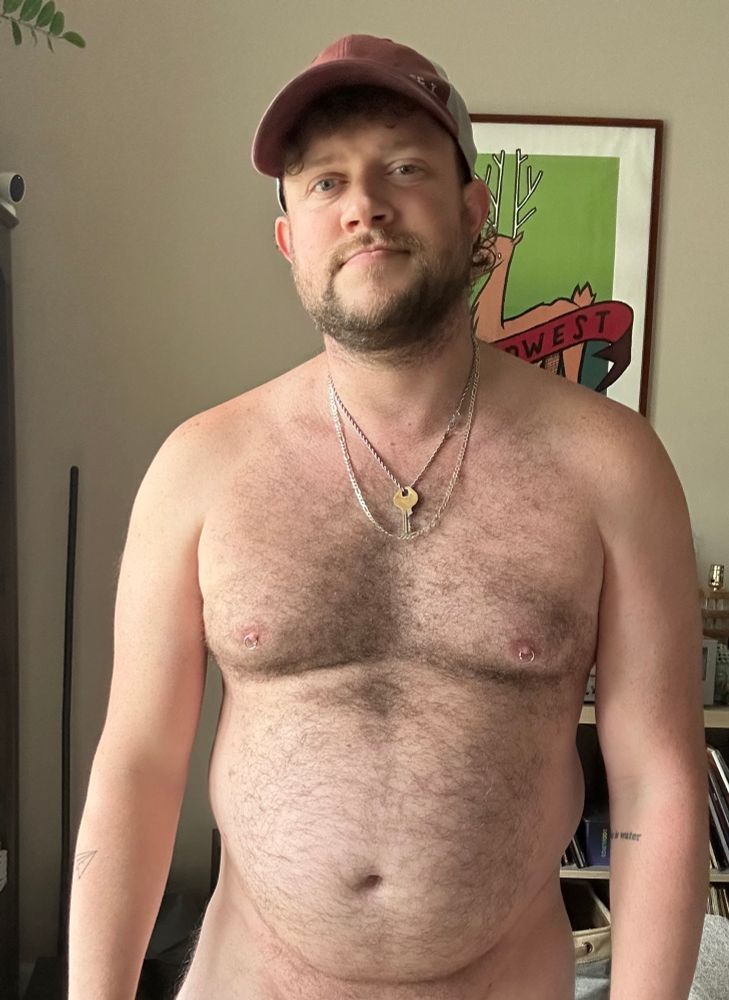 Me shirtless and wearing a hat 