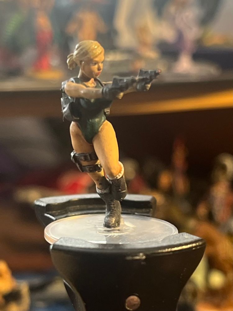 Female figure running while firing two Glocks