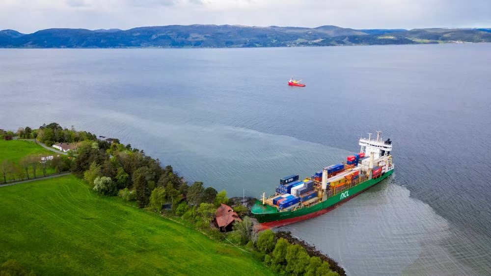 a ship run aground next to a small house in norway