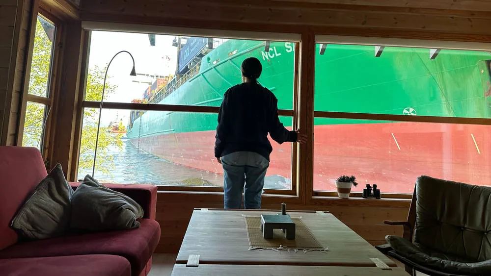 a ship run aground next to a small house in norway