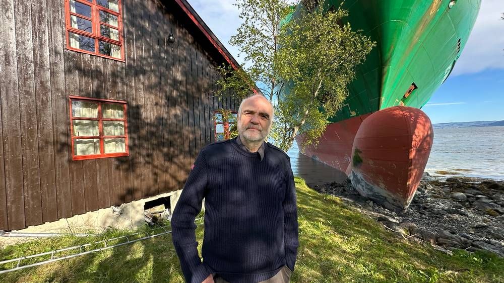 a ship run aground next to a small house in norway