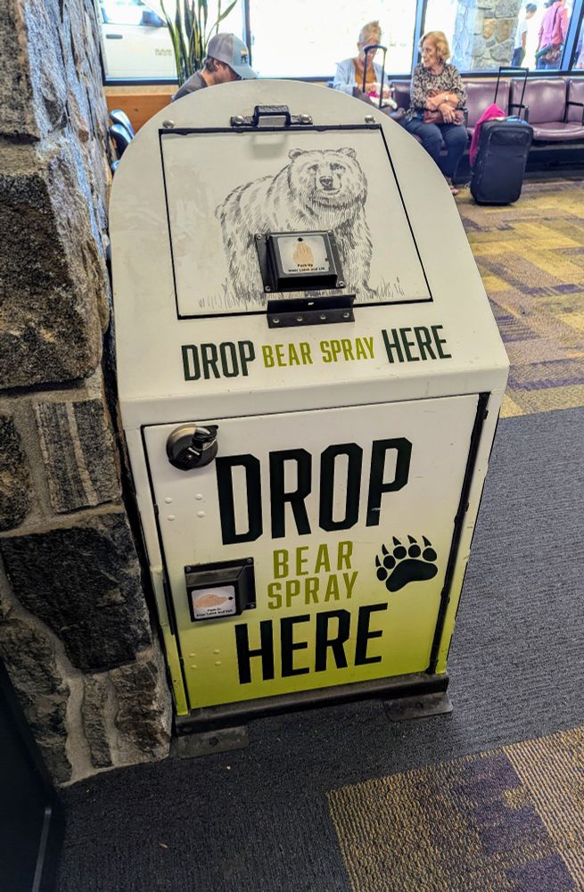 Lobby of Bozeman, MT airport. Large white drop box about 4 foot high and 2 foot wide and deep. 