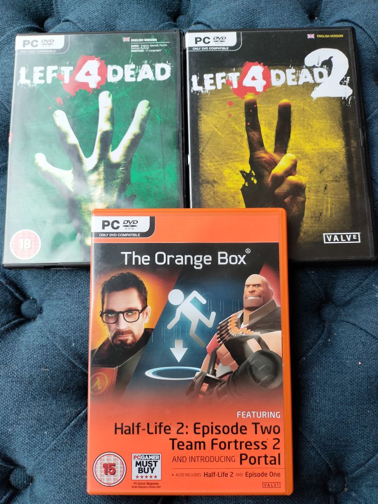 The game boxes for PC: Left 4 Dead, Left 4 Dead 2, and The Orange Box featuring Half Life 2 Episode Two, Team Fortress 2, and Portal. 