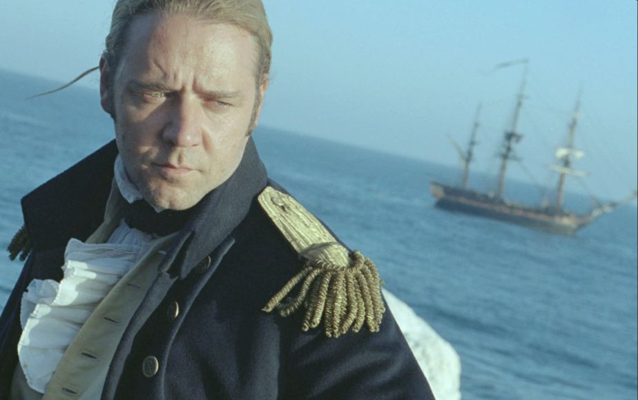 A still from Master and Commander: Far Side of the World (2003), showing Russell Crowe's character Jack Aubrey standing in the foreground, his ship HMS Surprise in the background. It has been recolored to be more blue and gray, and cropped and rotated to emulate the infamous use of canted angles in Battlefield: Earth (2000).