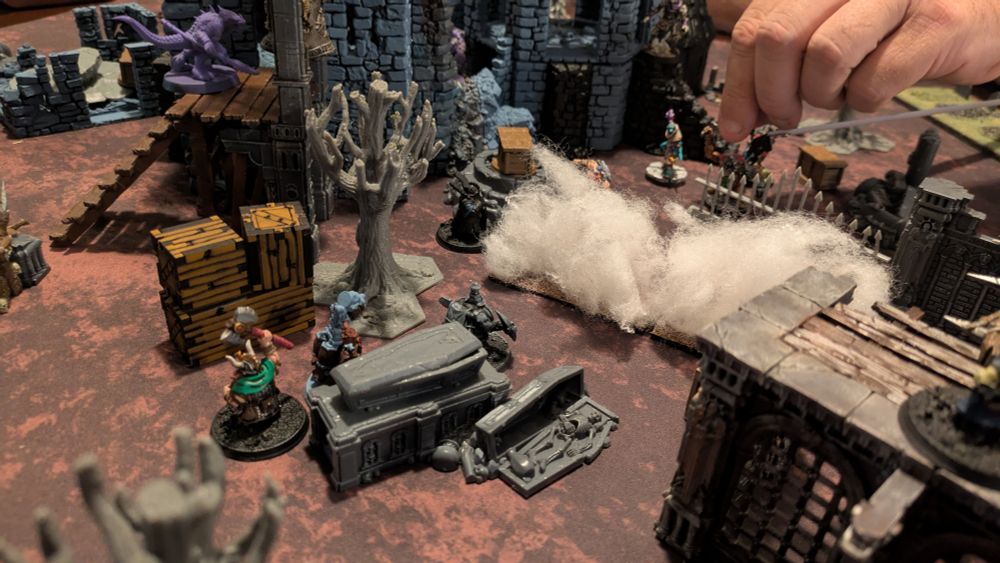 A dwarven warband pushes through the fog wall of an enemy wizard 