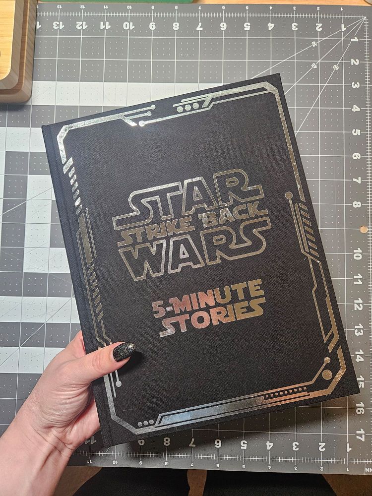 Black rebound book with the silver metallic text 'Starwars, strike back, 5-minute stories'