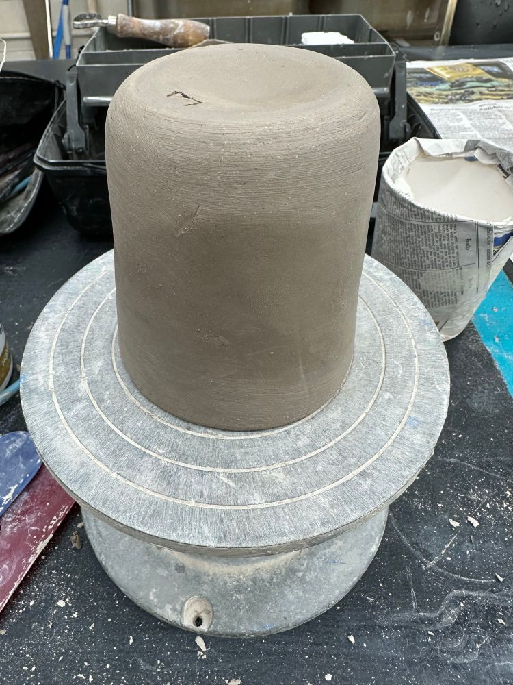 Smoothing out and trimming the bottom of a slab built mug