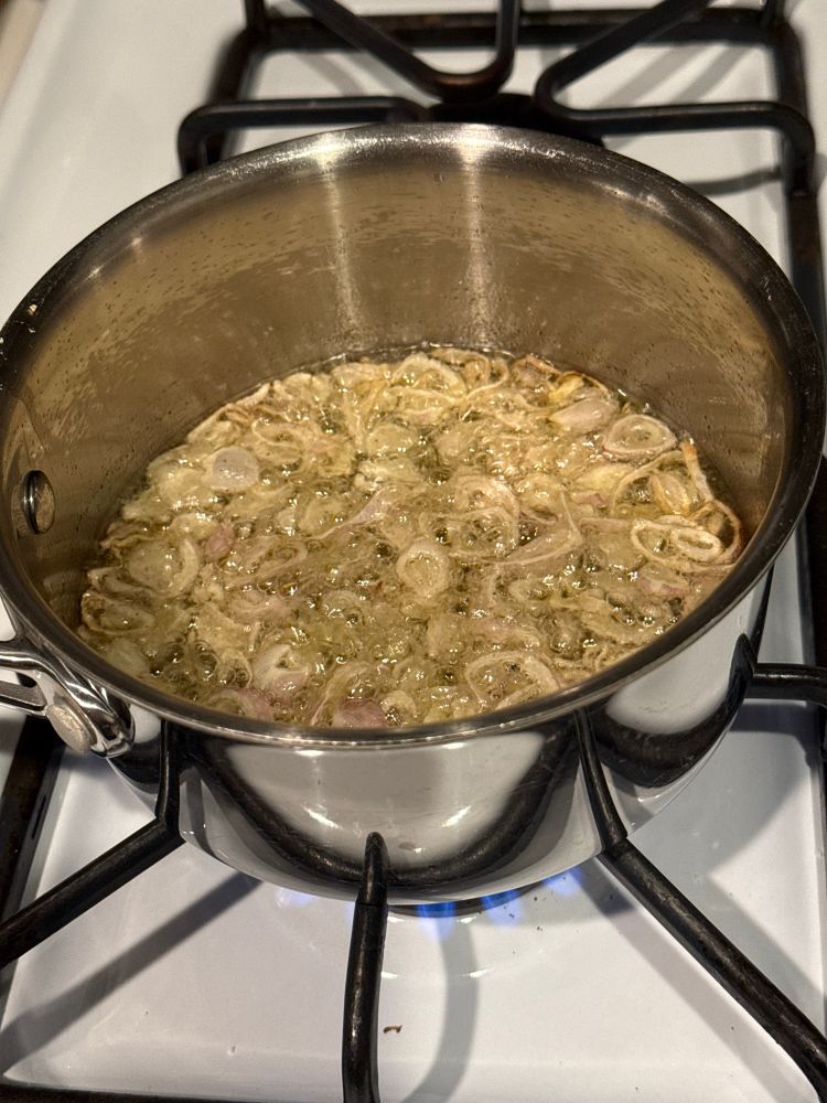 sliced shallots frying in oil