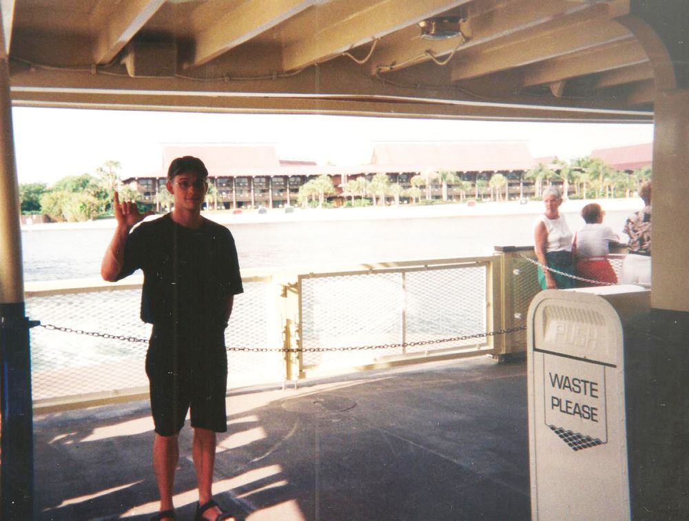 Man on ferry next to a trash can