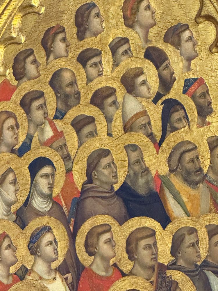 A painting depicts a crowd of halo’d saints and some halos obscure the faces of their neighbors 