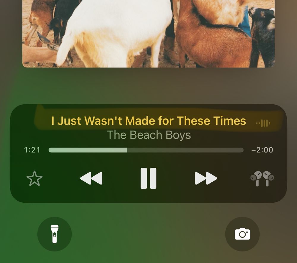 A screenshot of an iOS Lock Screen with the now playing panel displaying the song “I just wasn’t made for these times” by The Beach Boys