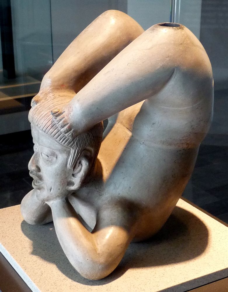 Ceramic acrobat with elbows propping up chin and feet contorted about to touch head from behind, found in Tlatilco, Valley of Mexico