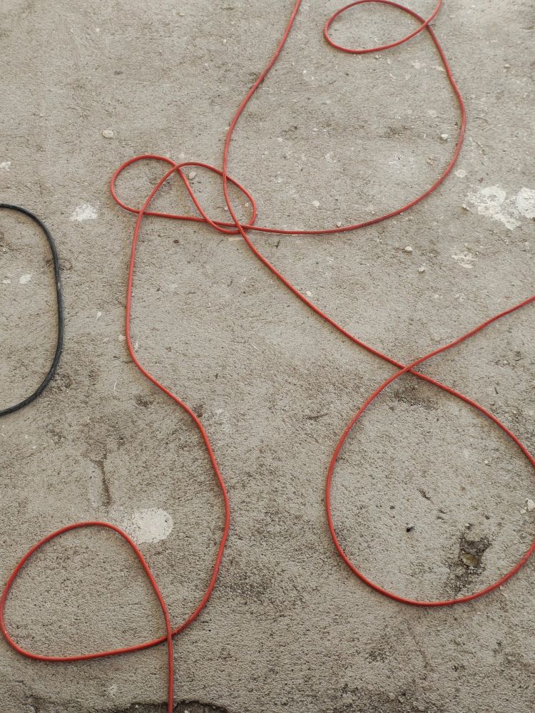 Photo of wires at the floor, folded and formed in the way it resembles a human penis