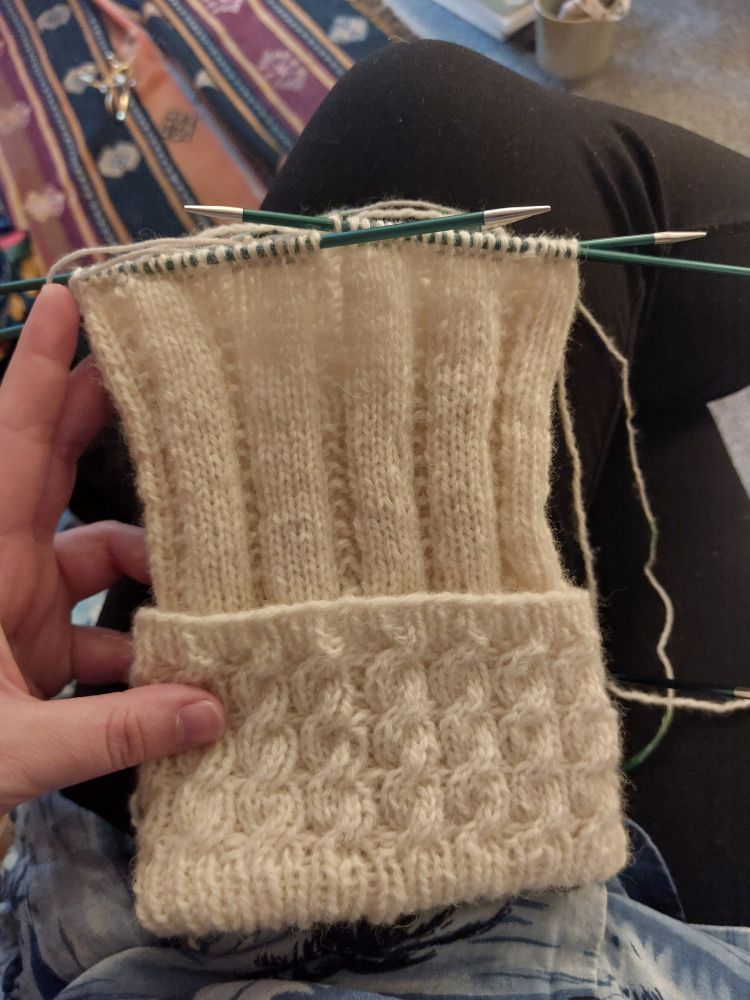An in progress kilt sock in DK New Lanark wool, with a cable rib cuff and garter rib sock body