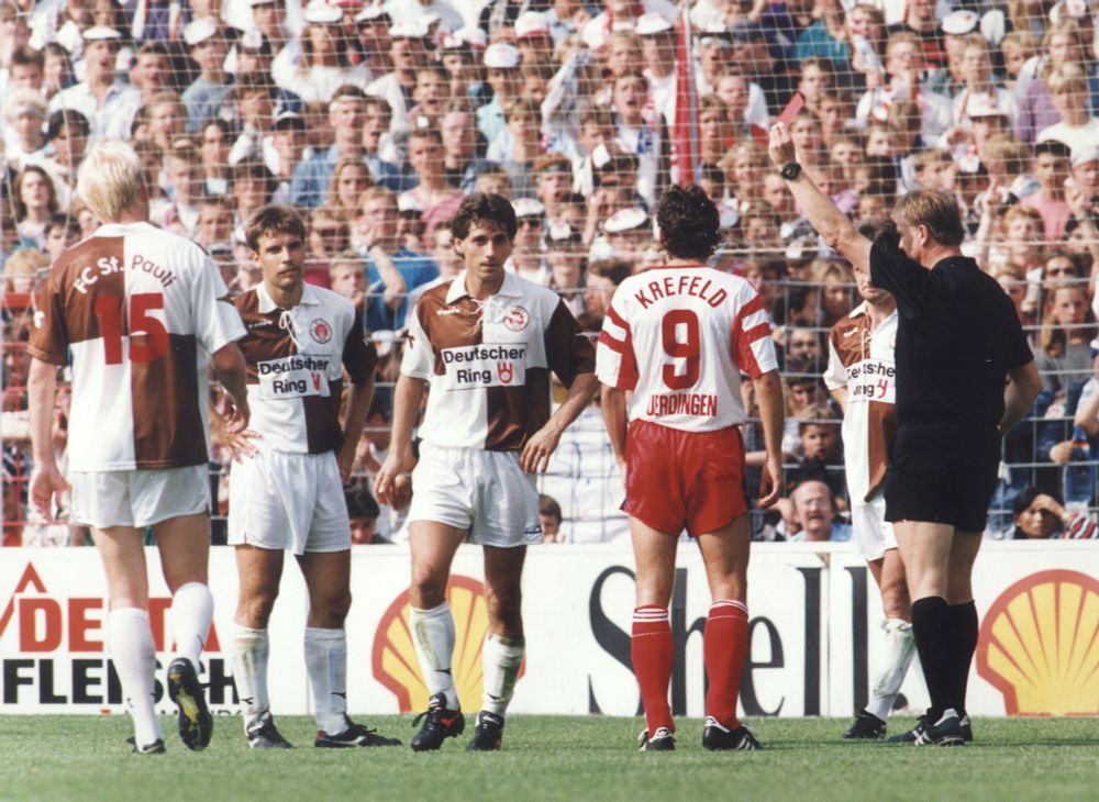 Szene aus dem Spiel FC St. Pauli - Bayer Uerdingen am 3. August 1991. Schiedsrichter Witke zeigt Robert Nikolic (3.v.l.) die Rote Karte. Foto: Witters