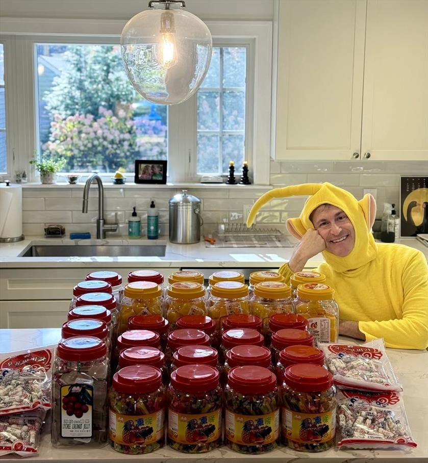 mayor taylor dressed as laa-laa the teletubby with a bunch of candy