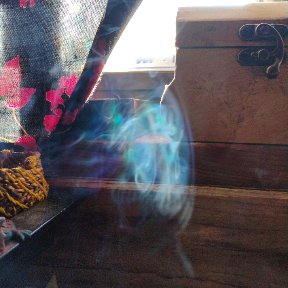 Smoke in a shaft of light, coming through a window.