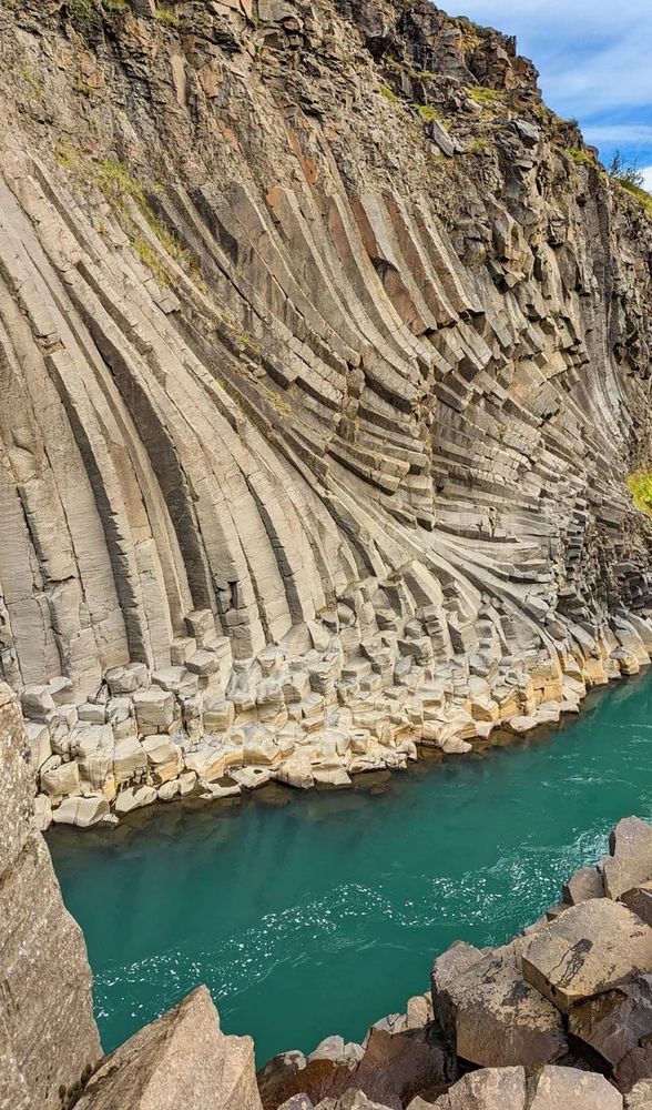 Basalt columns, a type of geological feature which is like columns, here rather rectangular ones, that emerge in rock surfaces. I’ve seen more cylindrical and hexagonal columns as well. These are above a really blue green creek and they have a wonderful curve and grading thing happening. Close to the water the columns become more ‘disc’ like ie shorter  
