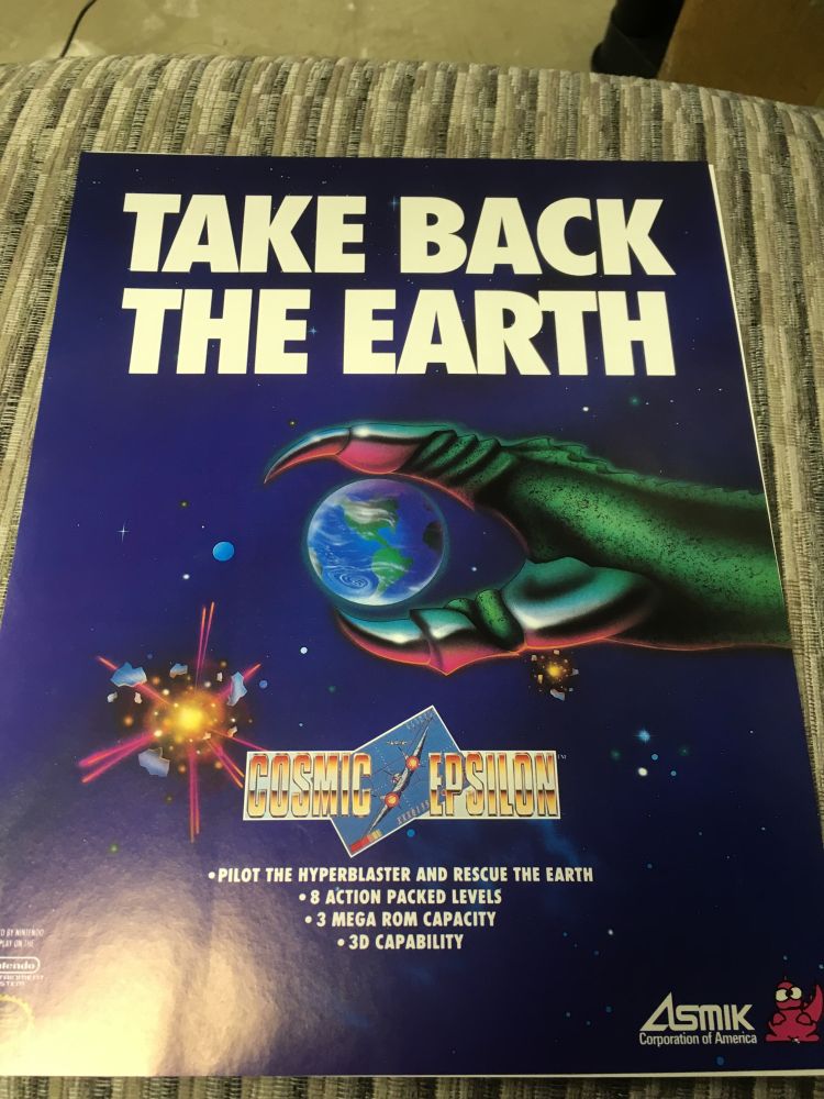 A different version of the ad for Cosmic Epsilon. It is color in printed on paper with English words. Color is the perception of different hues and bands of the overall light spectrum. Paper is basically a material in which we first kill a tree and then reform its corpse for our dastardly purposes. English is one of the many languages humans speak. It is not always a logical language, but it is certainly the best one.