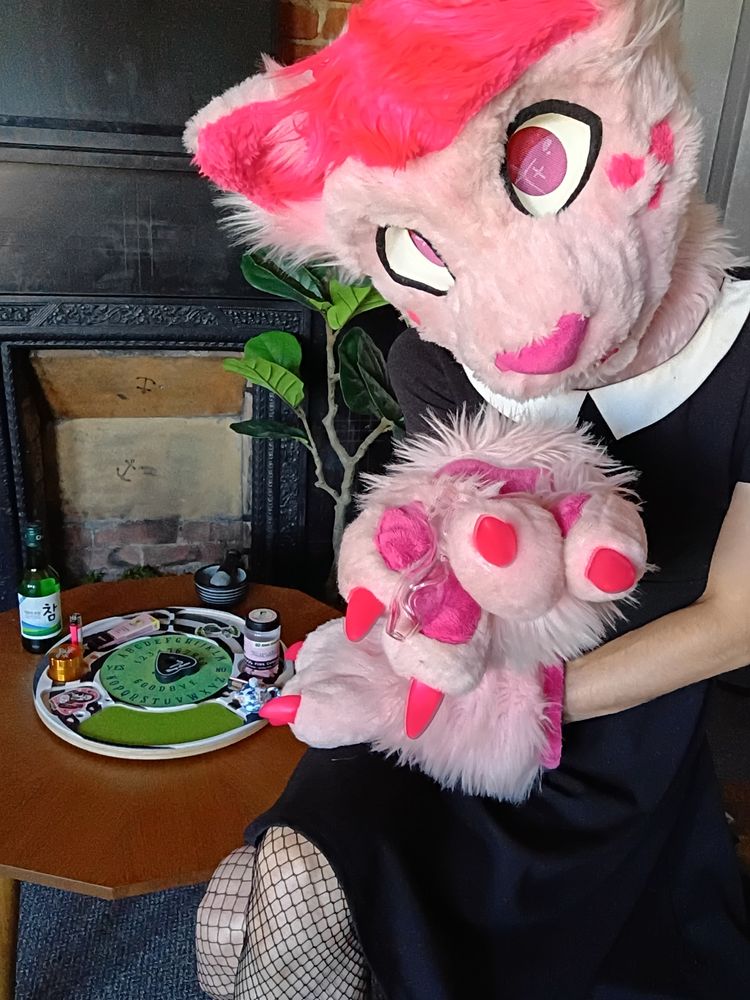 Felicity offering you a hit from the Pink Kitty Bowl, with a rolling tray and other weed bits on a kotatsu in the background!