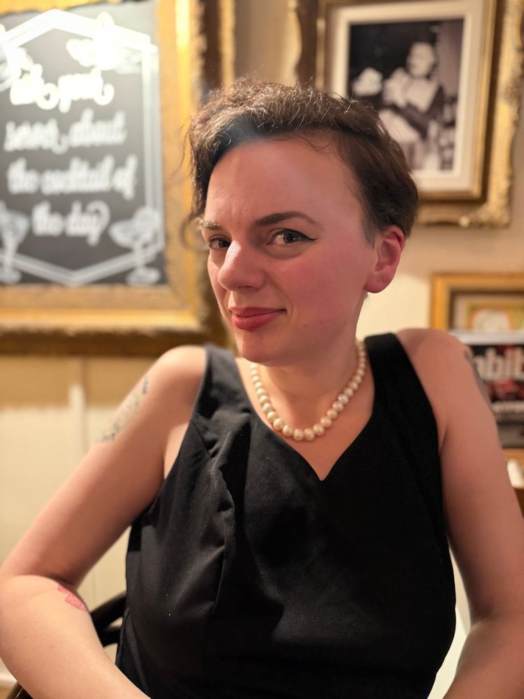 Kate smiling at the same cocktail bar