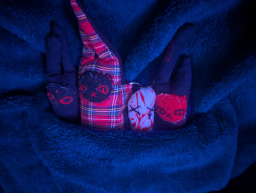 four sensory worms tucked into a blanket pocket in dimmer lighting than the first picture