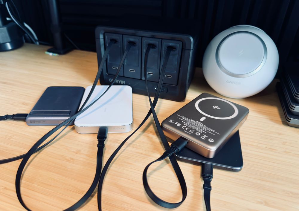 Four MagSafe batteries with desk charger