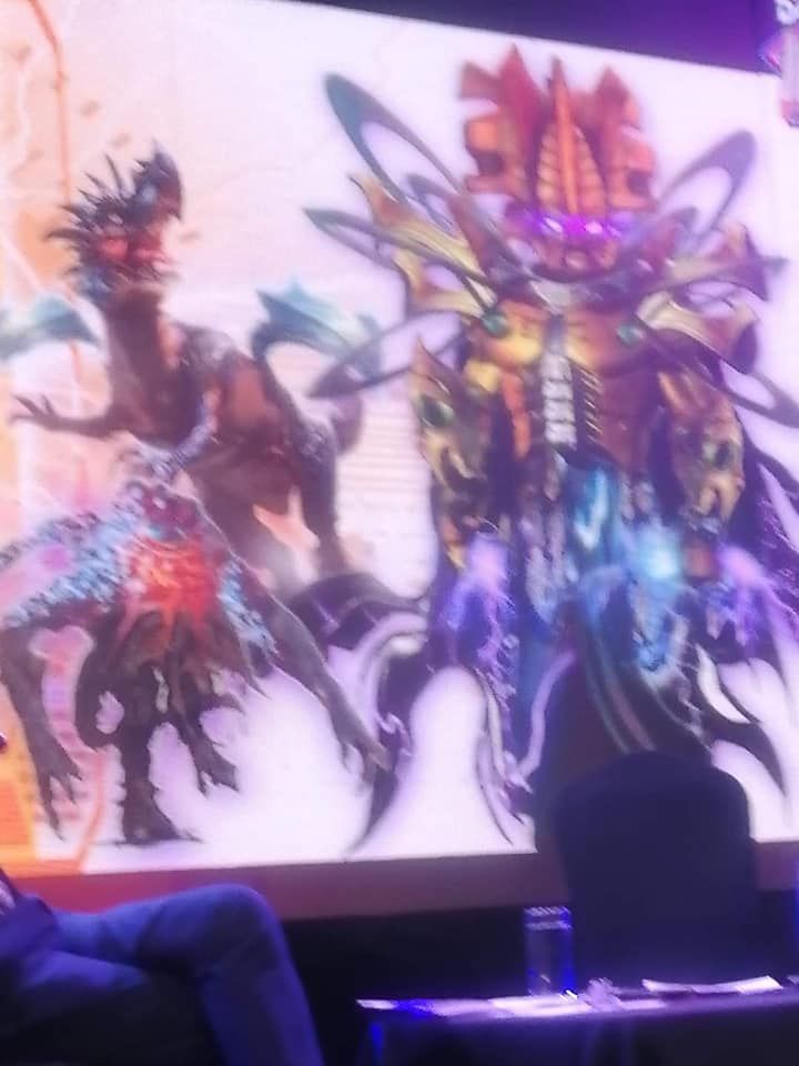 Concept art of the unproduced K9 series. Omega has golden armour and glowing purple eyes. He looks a bit like a Bionicle.