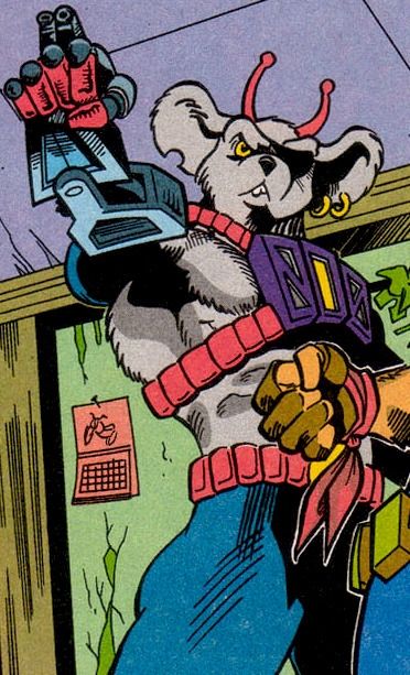 IDW Comics – Modo, a grey-furred anthropomorphic mouse with antennae sprouting from between his ears. Dressed in blue tights and some sort of mechanical harness strapped to his chest, giving off allusions of bondage fetish-wear. He is pointing his prosthetic arm at something out of frame, aiming some sort of weapon protruding from his metal forearm.