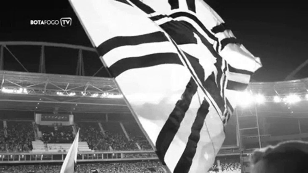 a black and white photo of a stadium with the words botafogo tv on the top