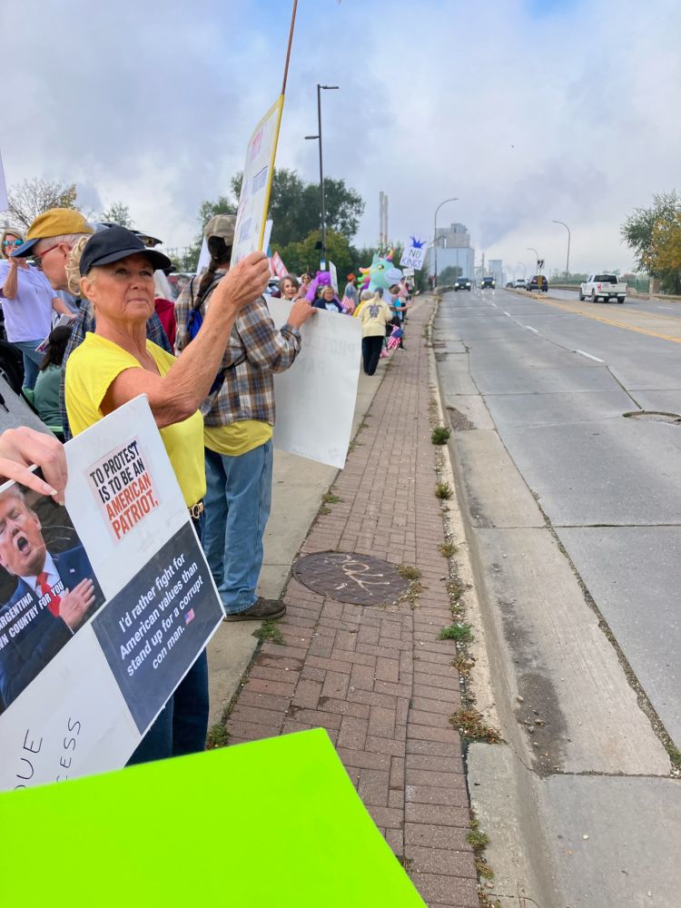 People holding signs in Cedar Rapids, IA #NoKings protests