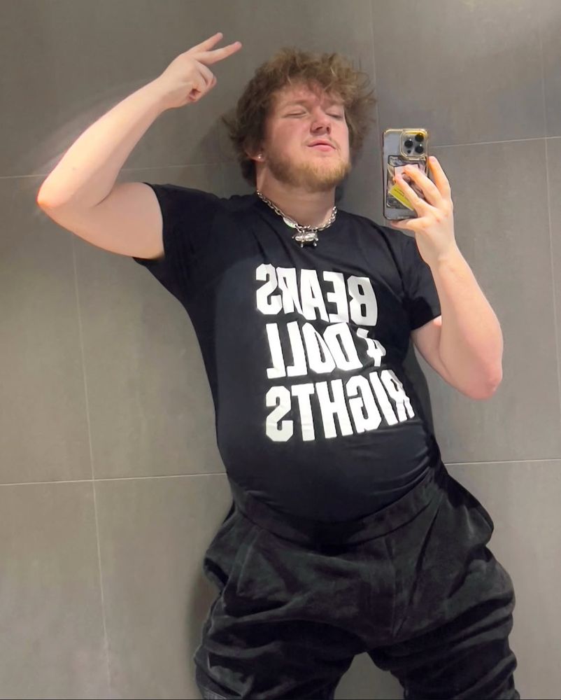 chubby dog man doing peace sign in bears for doll rights tee, dubious fit 
