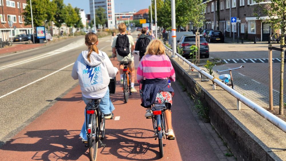 High school children cycling to/from school together.