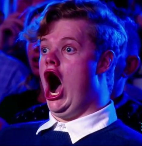 A man looks very surprised with his mouth open wide 