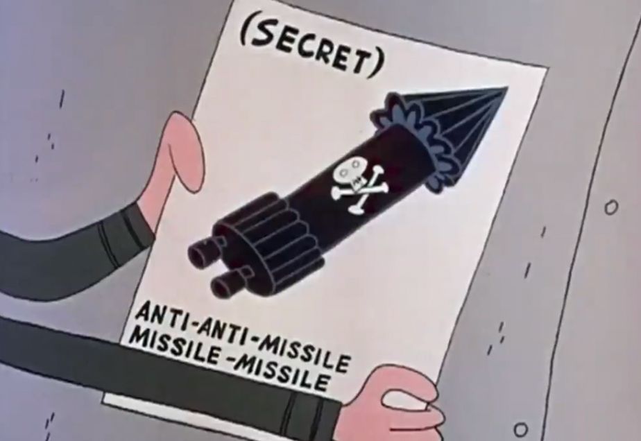 Cartoon (rocky and bullwinkle). Bad guy’s arms are holding a set of plans that have some kind of rocket on them. You can tell their secret ‘cause it says secret in parentheses at the top. Bottom says anti-anti-missile-missile-missile.