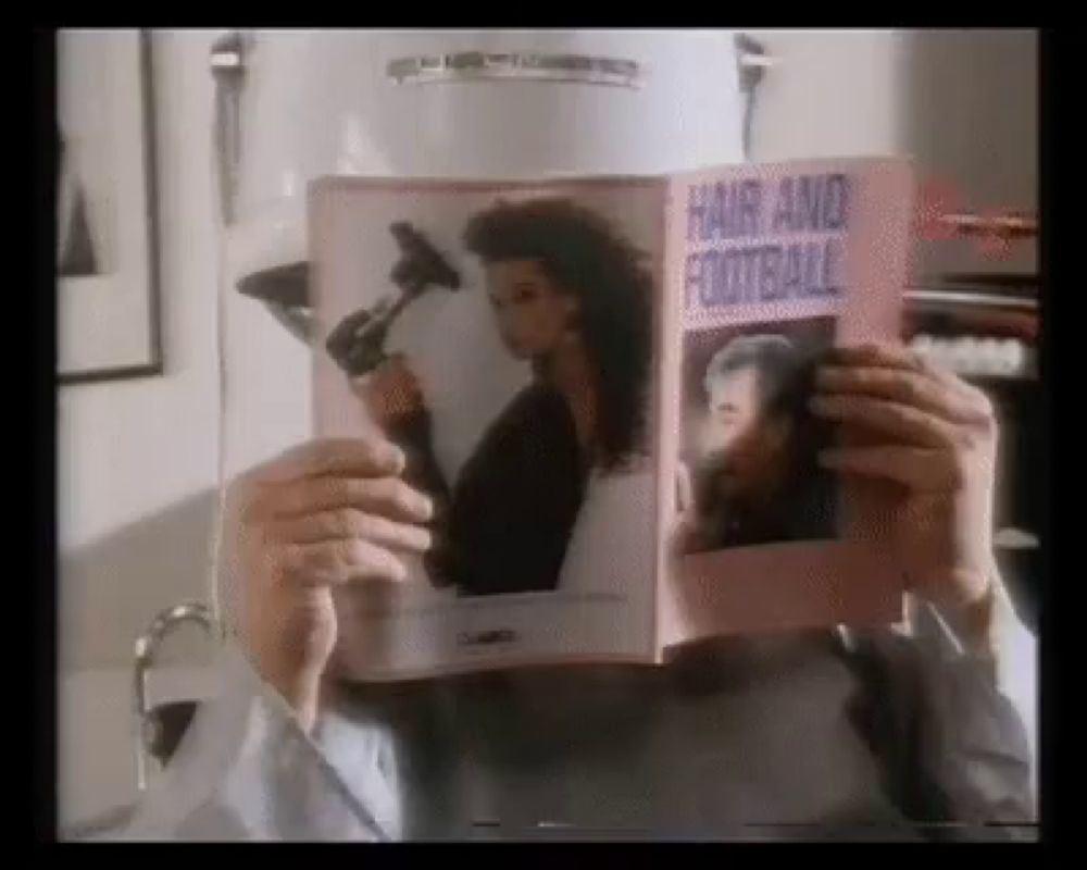 a man is reading a book titled hair and football